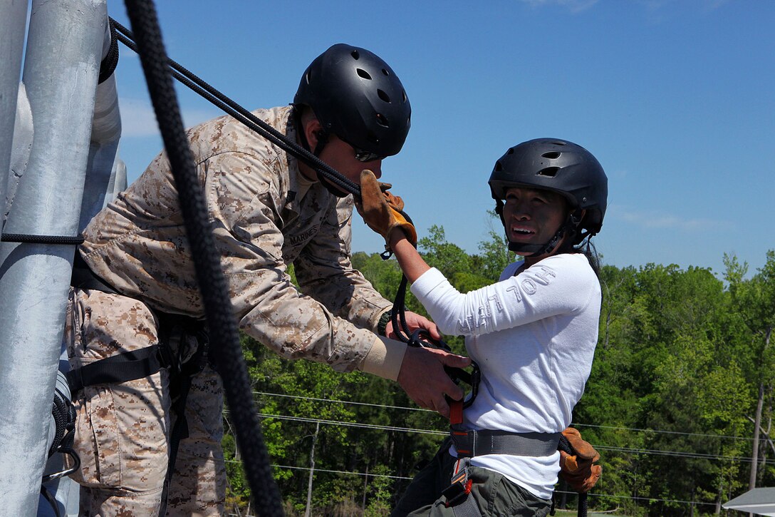 Marine spouses and children participate in a family day sponsored by U.S. Marine Corps Forces, Special Operations Command, April 26, 2013. The spouses shot live weapons, rappelled and were taught martial arts by Marine instructors. Children played games and did modified exercises during the event. Static displays showed MARSOC weapons and gear. After all the events the Marines and families had a barbecue.   
