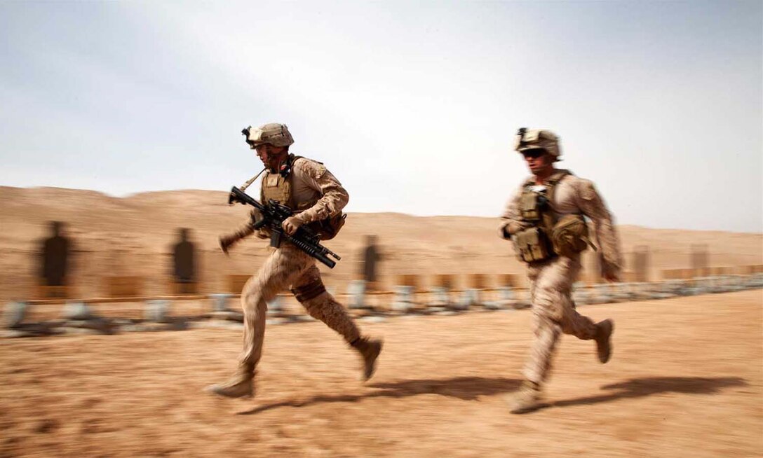 U.S. Marine Corps 1st Lt. Conor Shannon, left, and Cpl. Jared Bailey, both assigned to Afghan National Civil Order Police Kandak 1 Advisor Team, Regimental Combat Team 7, maneuver between stations while conducting small arms live fire
training on Camp Leatherneck, Helmand province, Afghanistan, April 25, 2013.