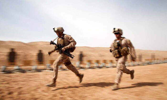 U.S. Marine Corps 1st Lt. Conor Shannon, left, and Cpl. Jared Bailey, both assigned to Afghan National Civil Order Police Kandak 1 Advisor Team, Regimental Combat Team 7, maneuver between stations while conducting small arms live fire
training on Camp Leatherneck, Helmand province, Afghanistan, April 25, 2013.