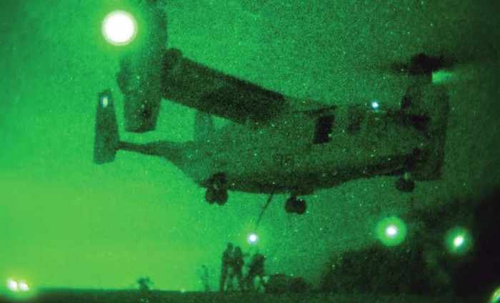 Marines hook a 7,000-pound concrete block to an MV-22B Osprey during external lift training at the Kin Blue Training Area near Camp Hansen May 9. The Marines are landing support specialists with Combat Logistics Battalion 31, 31st Marine Expeditionary Unit.