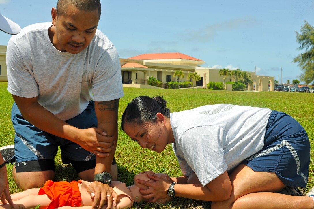 Senior Airman Andrew Long, 36th Medical Group pediatric medical technician, and Tech. Sgt. Rosalinda Mateo, 36th Medical Group Women’s Health Clinic NCO in charge, perform CPR on a toddler dummy during training on Andersen Air Force Base, Guam, May 8, 2013. The 36th MDG held combat-based training as part of National Nurse Week, May 6-12. The nurses and technicians trained on assessing patients, CPR, care under fire and other SABC tasks.(U.S. Air Force photo by Senior Airman Robert Hicks/Released)