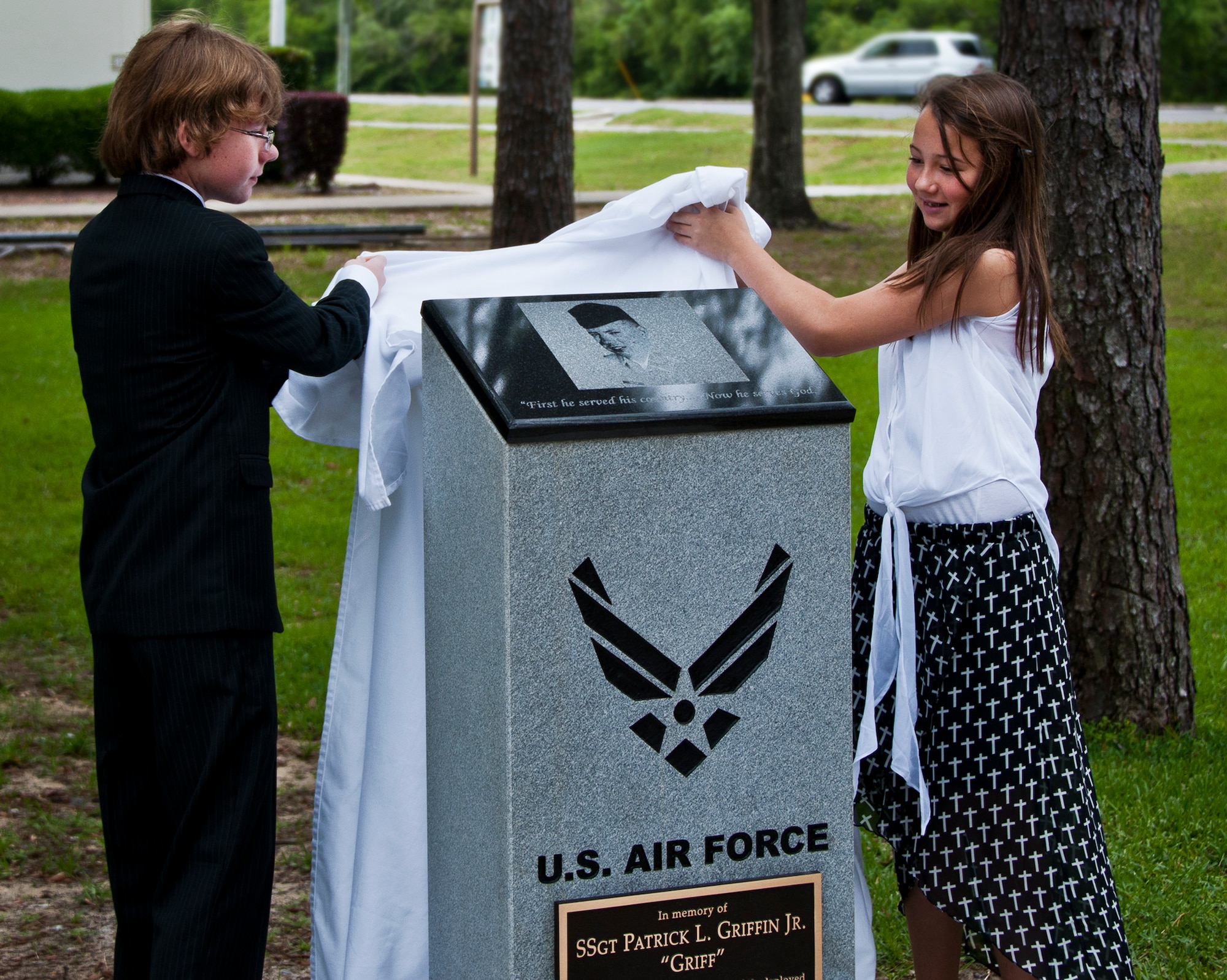 Corey and Makensie unveil their father’s memorial at the Staff Sgt. Patrick Griffin Memorial Rededication Ceremony May 16 at Eglin Air Force Base, Fla.  Griffin, a member of the 728th Air Control Squadron, was the only Eglin casualty of Operation Iraqi Freedom when he was killed by a roadside bomb May 13, 2003.  His memorial was moved from the 728th ACS building, which will be deactivated May 17, to its new location close to the 33rd Fighter Wing’s Khobar Towers Memorial.  (U.S. Air Force photo/Samuel King Jr.)
