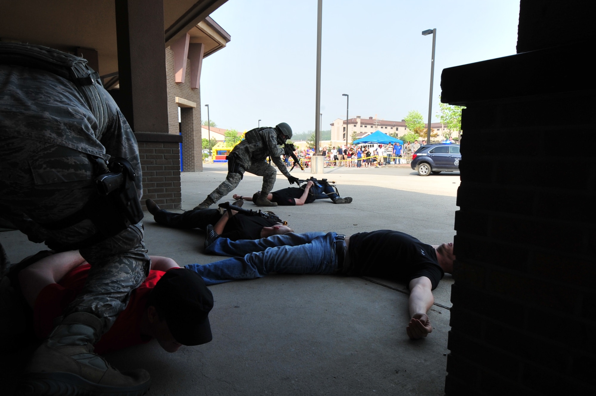 Quick Reaction Team members from the 51st Security Forces Squadron secure the area after eliminating a simulated bank robbery threat members in a demonstration at the Base Exchange on Osan Air Base, Republic of Korea, May 15, 2013. The demonstration took less than five minutes. (U.S. Air Force photo/Senior Airman Alexis Siekert)