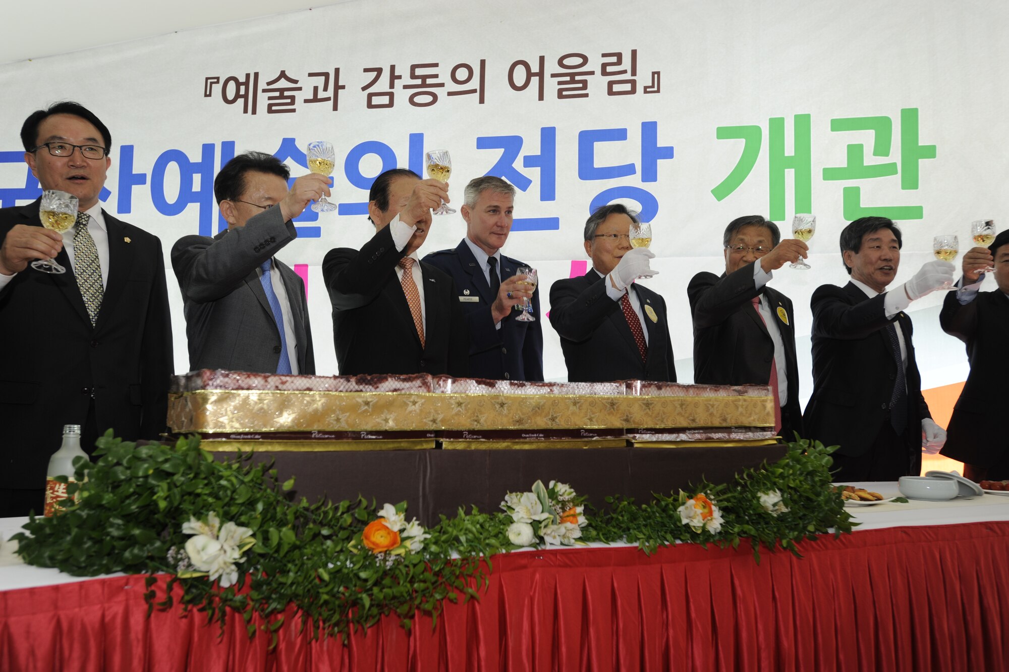 KUNSAN AIR BASE, Republic of Korea – Col. John Pearse, 8th Fighter Wing commander, center, along with South Korean provisional wide government officials toast after the arts center cake cutting ceremony, at Gunsan City, Republic of Korea May 1, 2013. Gunsan City officials and art association leadership were also in attendance during the art center opening, the largest in the city. (U.S. Air Force Photo by Staff Sgt. Tong Duong)