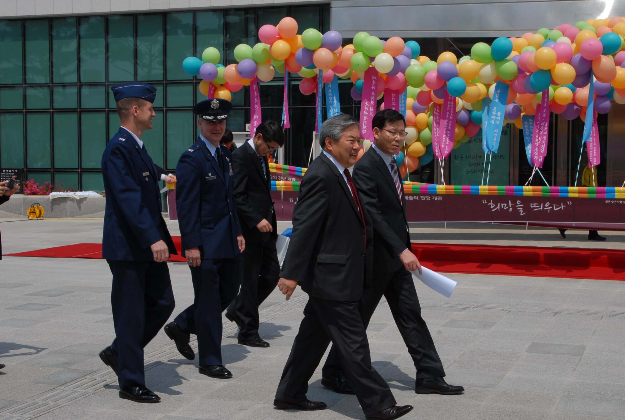 KUNSAN AIR BASE, Republic of Korea – Col. John Pearse, 8th FW commander,  back row center, and Col. Douglas Nikolai, 8th FW vice commander, back row left, arrives for the opening ceremony of the arts center, at Gunsan City, Republic of Korea, May 1, 2013. The new center features a main and small hall for concerts and musical performances. (U.S. Air Force Photo by Master Sgt. Sabrina Johnson/ released)