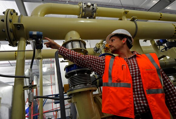 Greg Mitchell, JBER Landfill gas plant operator, checks the pressure on the landfill gas processing module, being constructed at the Anchorage Landfill, Aug. 21, 2012.  The module cleans and dries the landfill gas before it is sent to the plant. (U.S. Air
Force photo/Tech. Sgt. Brian Ferguson)