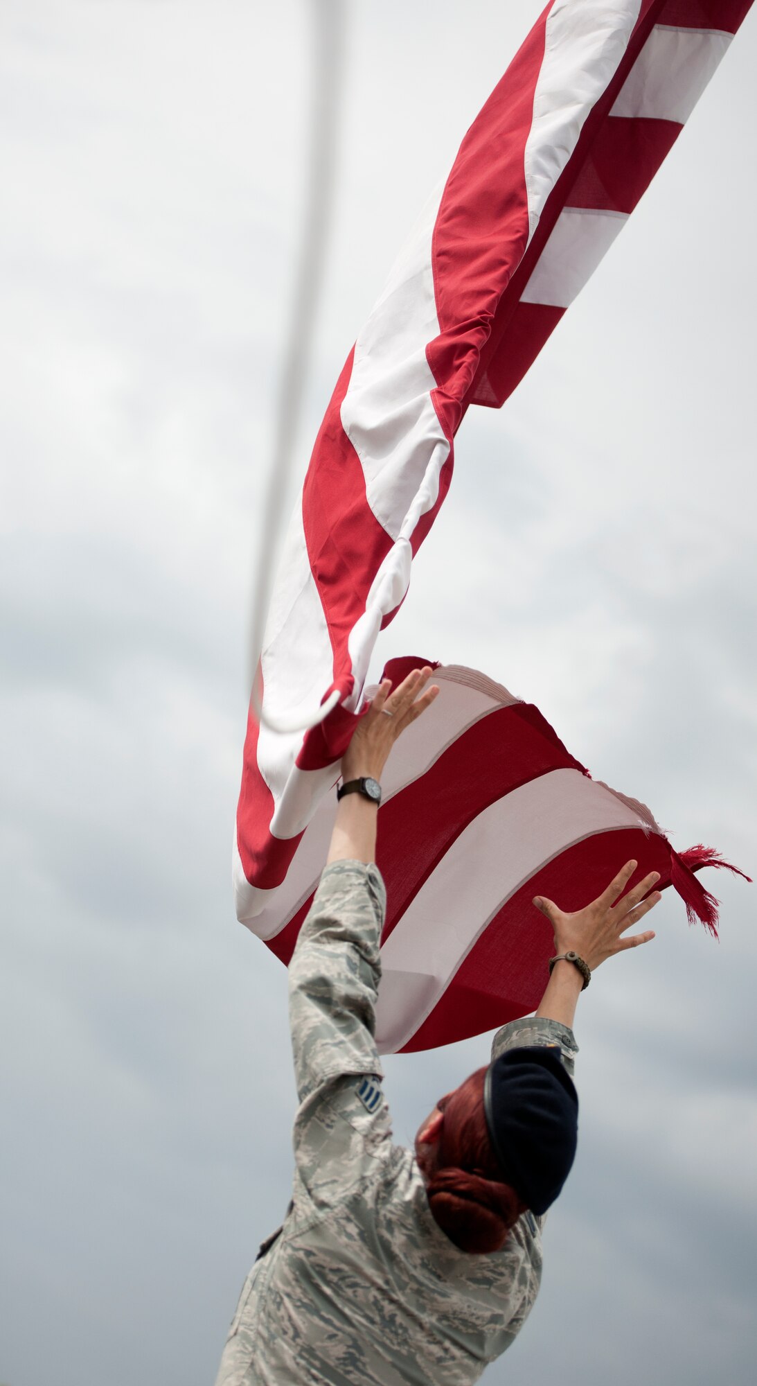 ALTUS AIR FORCE BASE, Okla. – Senior Airman Melissa Toon, 97th Security Forces Squadron patrolman, catches the American Flag during a retreat ceremony in observance of National Police Week at Wings of Freedom Park, May 15. The 97th SFS led the base in retreat in observance of National Police Week, which is held annually in honor of law enforcement officers killed or disabled in the line of duty. (U.S. Air Force photo by Senior Airman Jesse Lopez / Released)