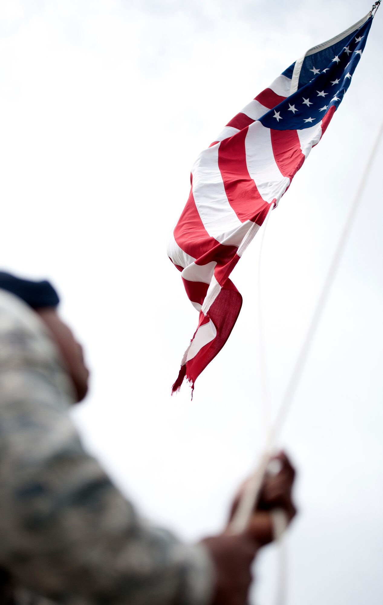 ALTUS AIR FORCE BASE, Okla. – Senior Airman Howard Huff, 97th Security Forces Squadron patrolman, raises the American Flag during a retreat ceremony in observance of National Police Week at Wings of Freedom Park, May 15. National Police Week is held annually in throughout the United States and internationally to honor police officers who died while in the line of duty. (U.S. Air Force photo by Senior Airman Jesse Lopez / Released)