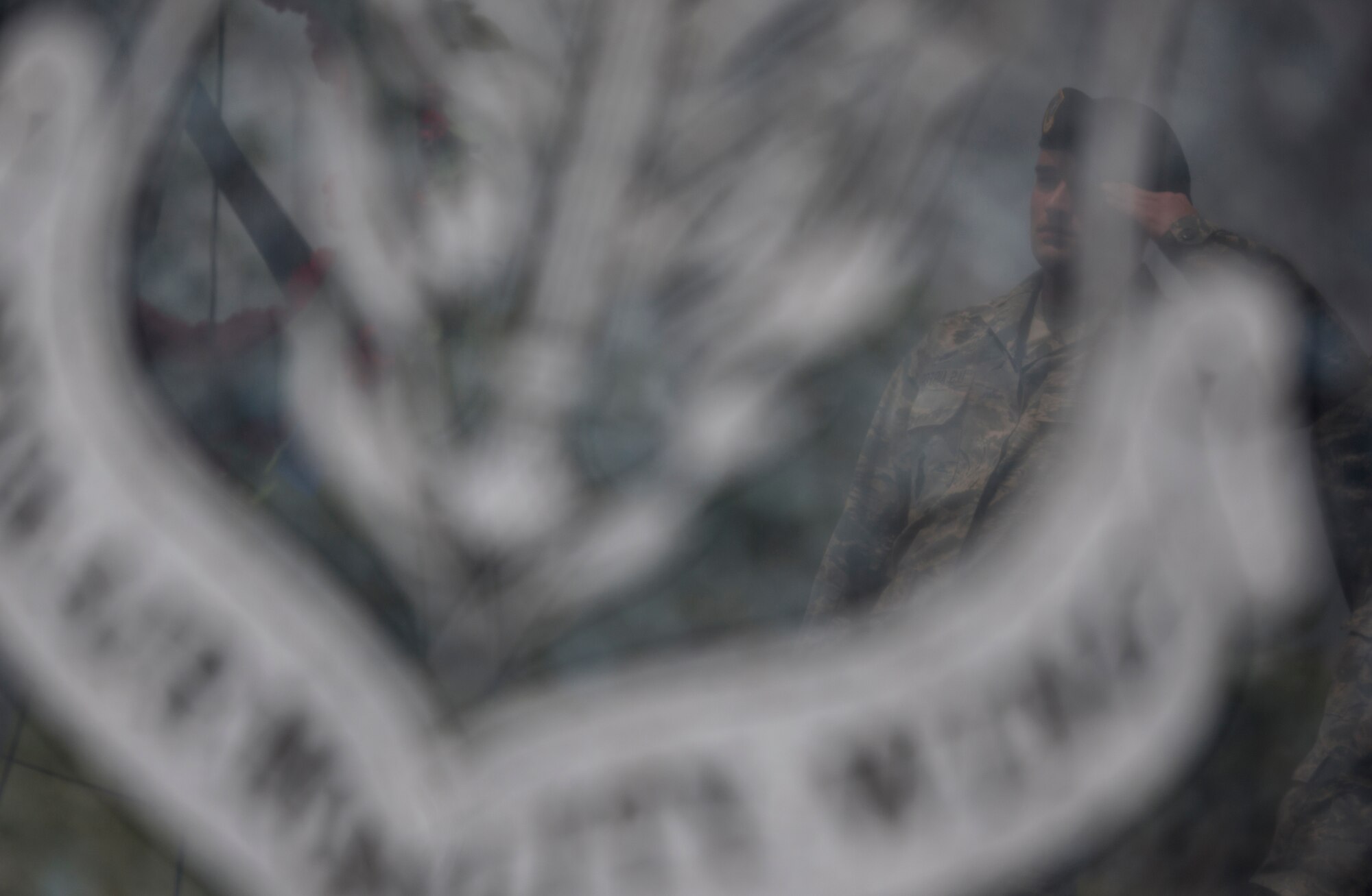 ALTUS AIR FORCE BASE, Okla. – Airman 1st Class Andrew Ausman, 97th Security Forces Squadron patrolman, renders a salute while performing the “Guarding of the Wreath” at Wings of Freedom Park, May 15. In observance of National Police Week, the 97th SFS performed the “Guarding of the Wreath” shortly after reveille. National Police Week pays special recognition to those law enforcement officers who have lost their lives in the line of duty for the safety and protection of others. (U.S. Air Force photo by Senior Airman Jesse Lopez / Released)