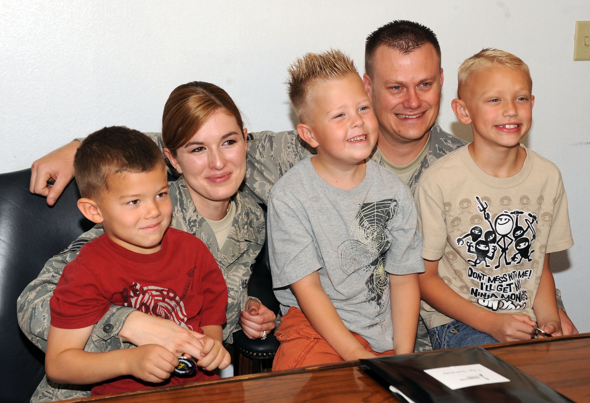 U.S. Air Force Tech. Sgt. Chad Brady, 355th Equipment Maintenance Squadron, poses for a photo with his family in the 355th EMS conference room at Davis-Monthan Air Force Base, Ariz., May 10, 2013. Brady is to be honored as the D-M Father of the Year in June 2013. (U.S. Air Force photo by Senior Airman Timothy Moore/Released)