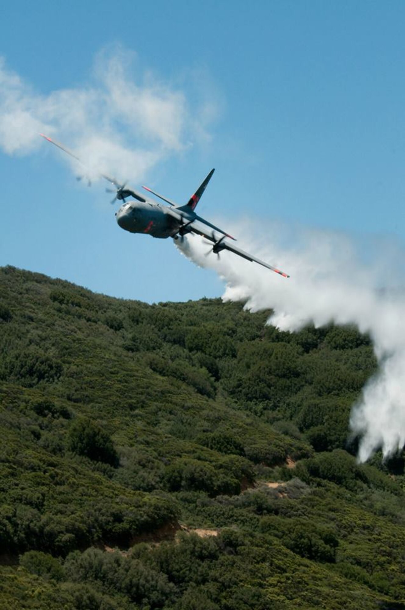 C-130J from the 146th Airlift Wing performs a water drop for training in the Angeles National Forest May 14, 2013. (U.S. Air National Guard photo by Senior Airman Nicholas Carzis).