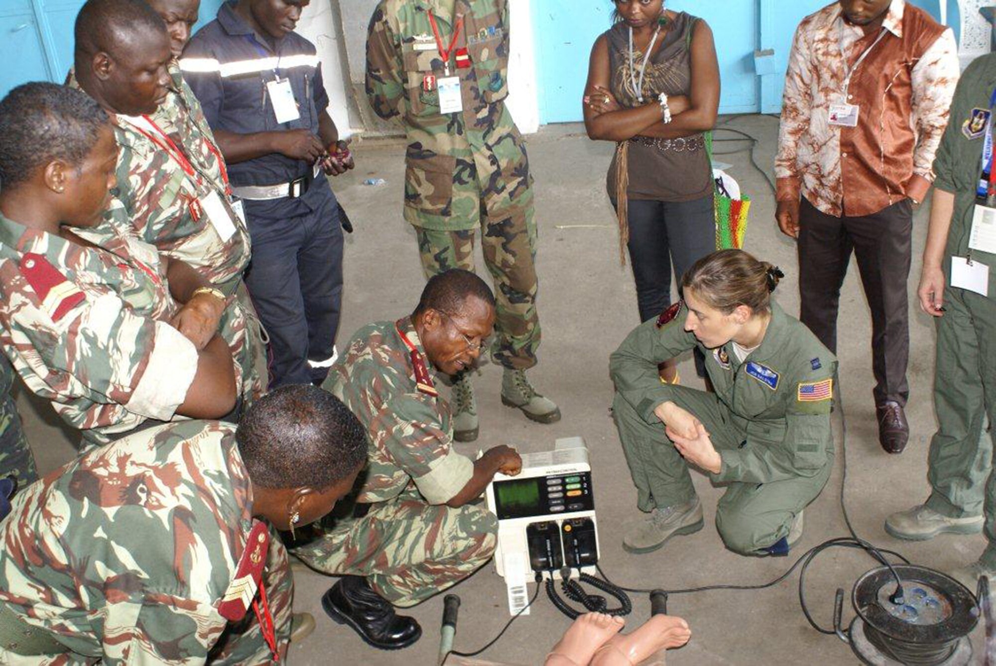 Maj. Jen Dalstra, an Air Force Reserve flight nurse, demonstrates how to use the Cameroon military's heart monitor/defibrillator and further explains that while in flight, aircraft vibrations will affect monitor readings. Dalstra’s students included military physicians, nurses and firefighters from the Cameroon military Forces.  Dalstra, and Chief Master Sgt. Debbie Buchanan, an aeromedical evacuation technician, were two of eight U.S. Air Force aeromedical crew members who participated in Central Accord 13, a 10-day exercise in Douala, Cameroon where U.S., Cameroonian, Barunde, Gabonese Republic, Democratic Republic of Condo, Republic of Congo and Sao Tome e Principe militaries trained Feb. 27 through Mar. 1. Both AF Reservists are assigned to the 34th Aeromedical Evacuation Squadron at Peterson Air Force Base, Colo. (U.S. Air Force photo/Master Sgt. Adam Rausch)