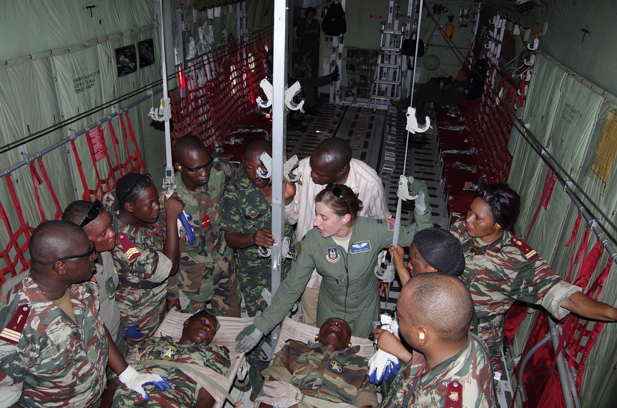 While in flight, Maj. Jen Dalstra, an Air Force Reserve flight nurse, instructs physicians and nurses from Cameroon, Gabon and the Democratic Republic of the Congo. This was the first time many of the medical professionals from the African countries had flown aboard a military aircraft. Dalstra and Chief Master Sgt. Debbie Buchanan, an aeromedical evacuation technician, were two of eight U.S. Air Force aeromedical crew members who participated in Central Accord 13, a 10-day exercise in Douala, Cameroon where U.S., Cameroonian, Barunde, Gabonese Republic, Democratic Republic of Condo, Republic of Congo and Sao Tome e Principe militaries trained Feb. 27 through Mar. 1. Both AF Reservists are assigned to the 34th Aeromedical Evacuation Squadron at Peterson Air Force Base, Colo. (U.S. Air Force photo/Master Sgt. Adam Rausch)