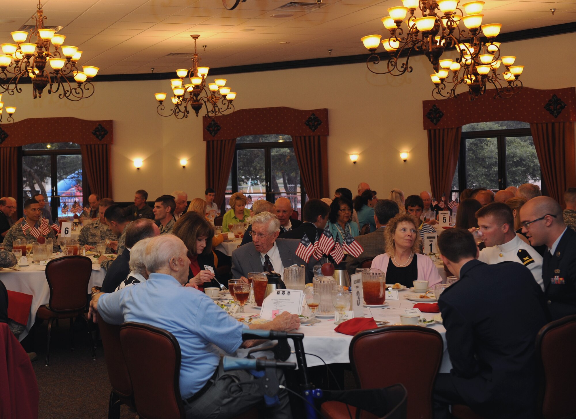 Service members past and present, and their families enjoy a meal in honor of retired U.S. Army Command Sgt. Maj. Gary Littrell, Medal of Honor recipient, on Barksdale Air Force Base, La., May 16, 2013. Littrell, sergeant first class at the time, received the Medal of Honor for his actions during the Vietnam War. Beginning with intense mortar attacks from the enemy, Littrell put himself in harm's way for days, repulsing the attacks and instilling his men with the will to resist. (U.S. Air Force photo/Airman 1st Class Benjamin Gonsier)
