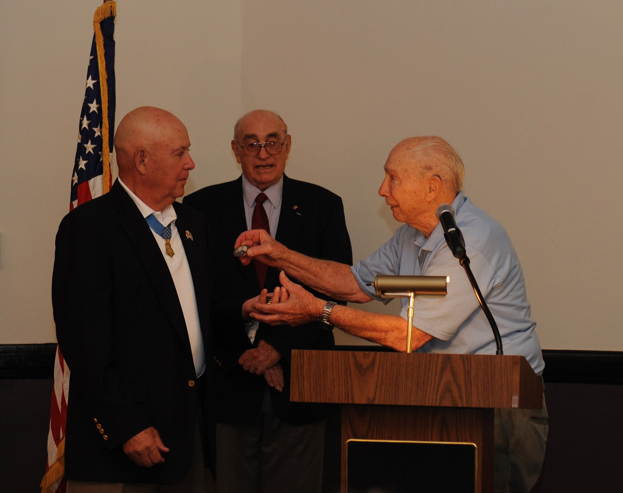 Retired U.S. Army Command Sgt. Maj. Gary Littrell, Medal of Honor recipient, receives a gift from Ret. Col. Steve dePyssler, Retiree Affairs office, on Barksdale Air Force Base, La., May 16, 2013. Littrell, sergeant first class at the time, received the Medal of Honor for his actions during the Vietnam War. Beginning with intense mortar attacks from the enemy, Littrell put himself in harm's way for days, repulsing the attacks and instilling his men with the will to resist. (U.S. Air Force photo/Airman 1st Class Benjamin Gonsier)

