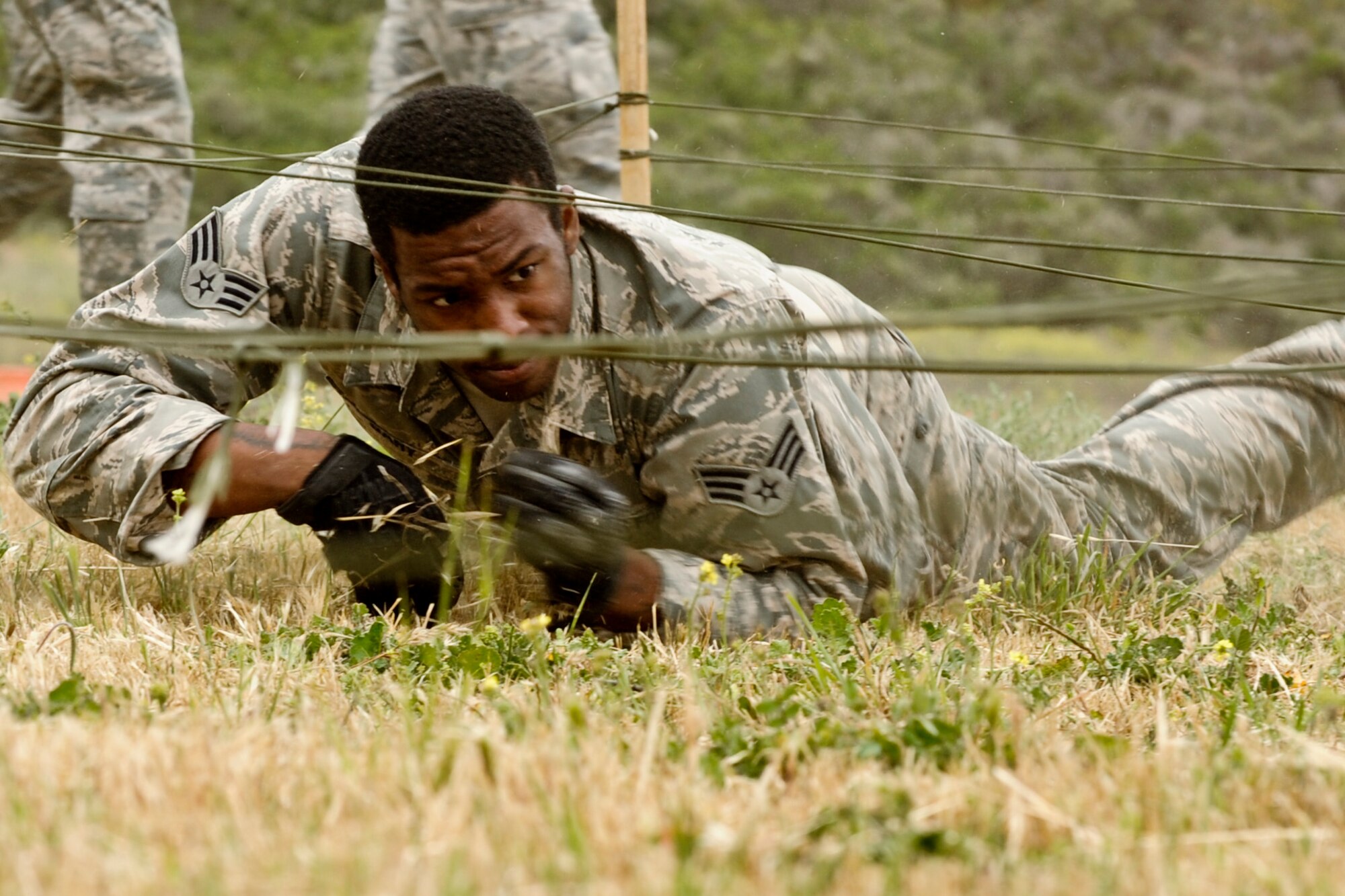 VANDENBERG AIR FORCE BASE, Calif. – Senior Airman Matthew Gary, a 30th Security Forces Squadron response force member, low crawls during a competition for National Police Week here Tuesday, May 14, 2013. The 30th Security Forces Squadron held this year’s West Coast Warrior Challenge Competition as part of their National Police Week ceremonies, meant to honor law enforcement officers who have lost their lives in the line of duty. (U.S. Air Force photo/Airman Yvonne Morales)