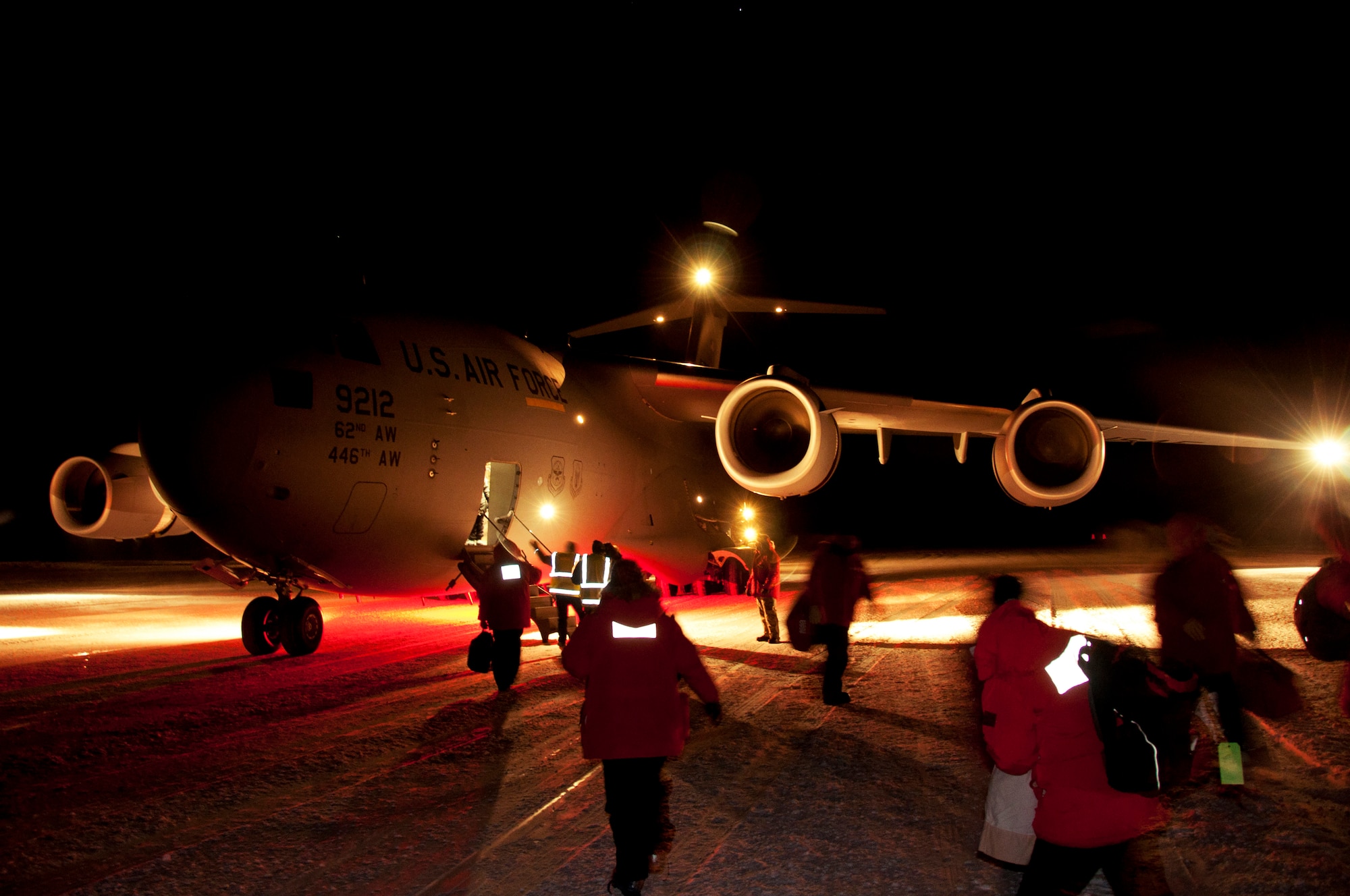 Passengers board a C-17 Globemaster III May 10, 2013 at McMurdo Station, Antarctica. Airmen from Joint Base Lewis-McChord, Wash., arrived to pick up an ailing contractor working at McMurdo and transported the patient to Christchurch, New Zealand, for further medical attention. (U.S. Air Force photo/Staff Sgt. Robert Tingle)