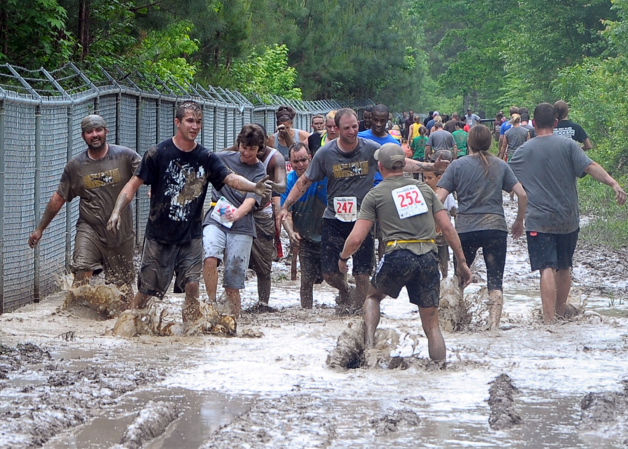 Participants in the Zombie Run held at Columbus Air Force Base May 11 run through a muddy lake while avoiding zombies. The lake was just one of the numerous obstacles the participants had to pass to finish the race. (U.S. Air Force Photo/ Airman 1st Class Stephanie Englar)