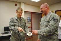 (Right) Tech. Sgt. Cory Anderson, 319th Medical Operation Squadron NCO in charge of Family Health, bursts into laughter at Airman 1st Class Kyle Cornelissen’s reaction of excitement of seeing another scoop of ice cream added to his bowl during an ice cream social May 7, 2013, on Grand Forks Air Force Base, N.D. The ice cream social was one of five events designed to show appreciation for nurses and medical technicians during this year’s Nurse-Tech Week. (U.S. Air Force photo/Staff Sgt. Luis Loza Gutierrez)