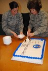 (Right)Lt. Col. Paula Winters, 319th Medical Group chief nurse, and 1st. Lt. Brenda Homan, 319th MDG clinical nurse, prepare slices of cake for guests attending this year’s Nurse-Tech Week Spelling Bee held May 6, 2013, at the Columbus Conference Room on Grand Forks Air Force Base, N.D. The desert and spelling bee were part of one of five events to take place as part of the 319th Medical Group’s Nurse-Tech Week. (U.S. Air Force photo/Staff Sgt. Luis Loza Gutierrez)