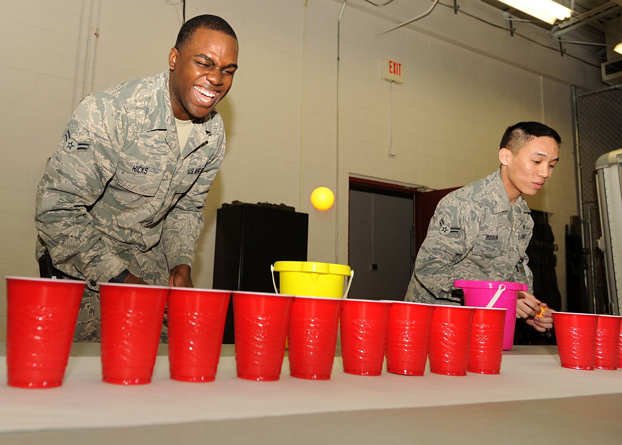 Airman 1st Class Andrew Hicks, left, and Airman 1st Class Mongeriq Barron, 319th Medical Group medical technicians, bounce plastic balls into cups during this year’s ambulance bay games on May 9, 2013, on Grand Forks Air Force Base, N.D. The games were one of five events to take place as part of the 319th Medical Group’s Nurse-Tech Week. (U.S. Air Force photo/Airman 1st Class Xavier Navarro)
