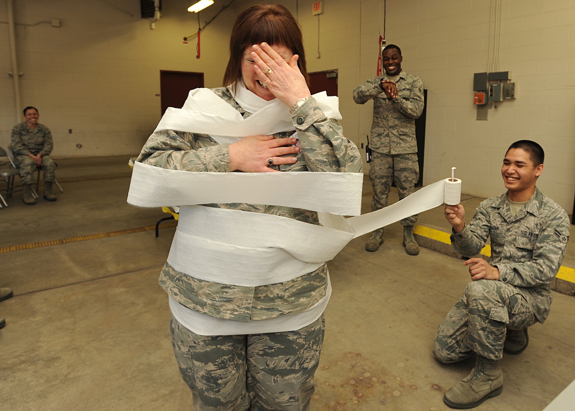 Airman 1st Class Paul Ilagan, 319th Medical Operation Squadron medical technician, helps transform Lt. Col. Paula Winters, 319th Medical Group chief nurse, into a toilet paper mummy during this year’s ambulance bay games held May 9, 2013, on Grand Forks Air Force Base, N.D. The games were one of five events to take place as part of the 319th Medical Group’s Nurse-Tech Week. (U.S. Air Force photo/Airman 1st Class Xavier Navarro)
