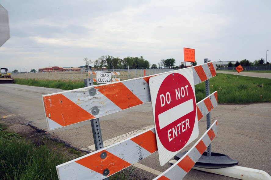 Road constructoins signs identify where crews have begun work on rerouting of State Route 794 by the Springfield Air National Guard Base, Springfield, Ohio. In the background is the newly constructed 251st Combat Communications Group facility and location where new main gate will be located.