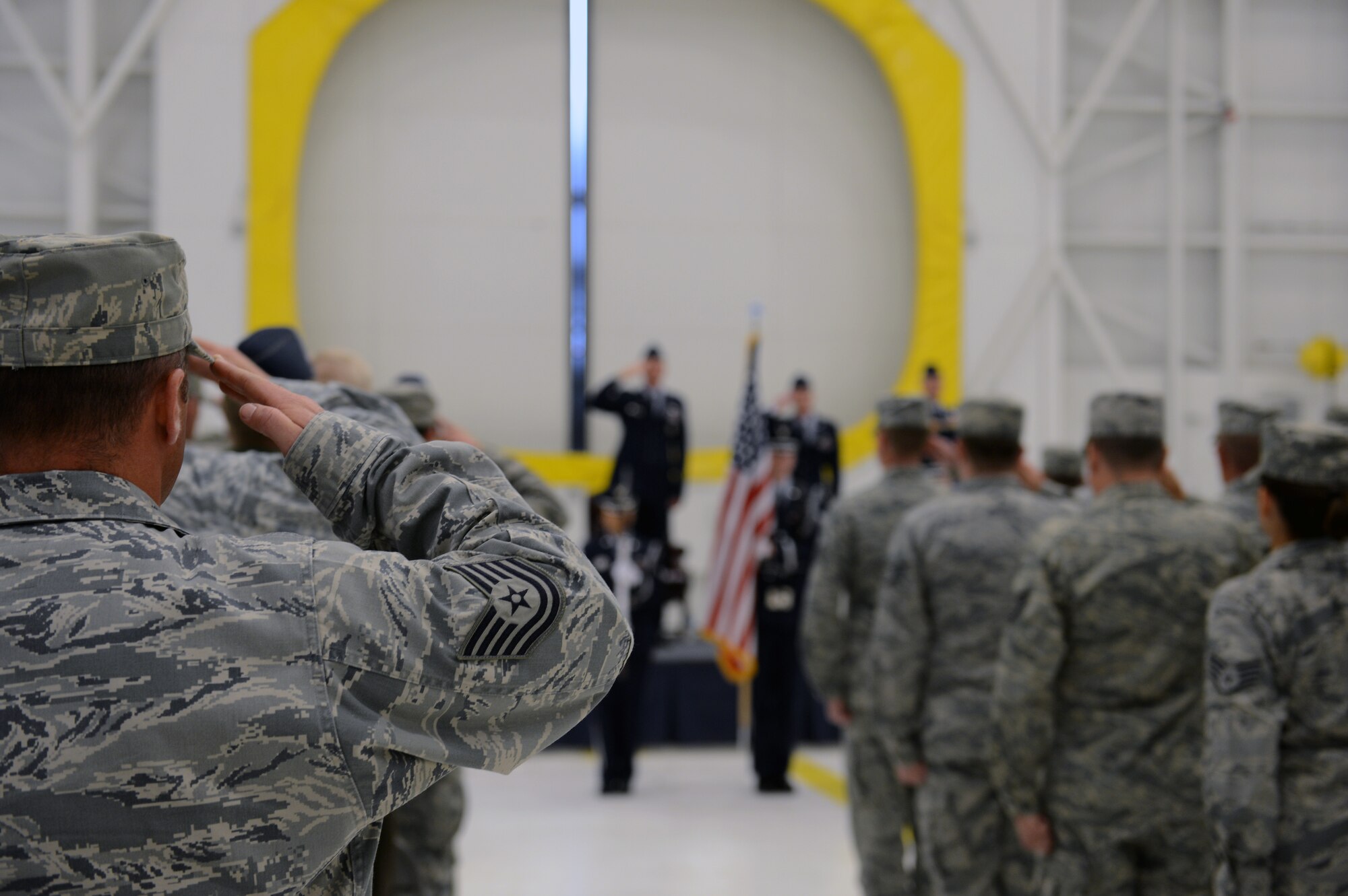 Attendees salute as the Team McChord Honor Guard post the colors during the 62nd Maintenance Operations Squadron Deactivation Ceremony May 13, 2013 at Joint Base Lewis-McChord, Wash. The 62nd MOS traces its roots back to World War II, and  was originally constituted as the 62nd Station Complement Squadron on May 15, 1943 at Walterboro Army Air Field, S.C. (U.S. Air Force photo/Staff Sgt. Jason Truskowski)