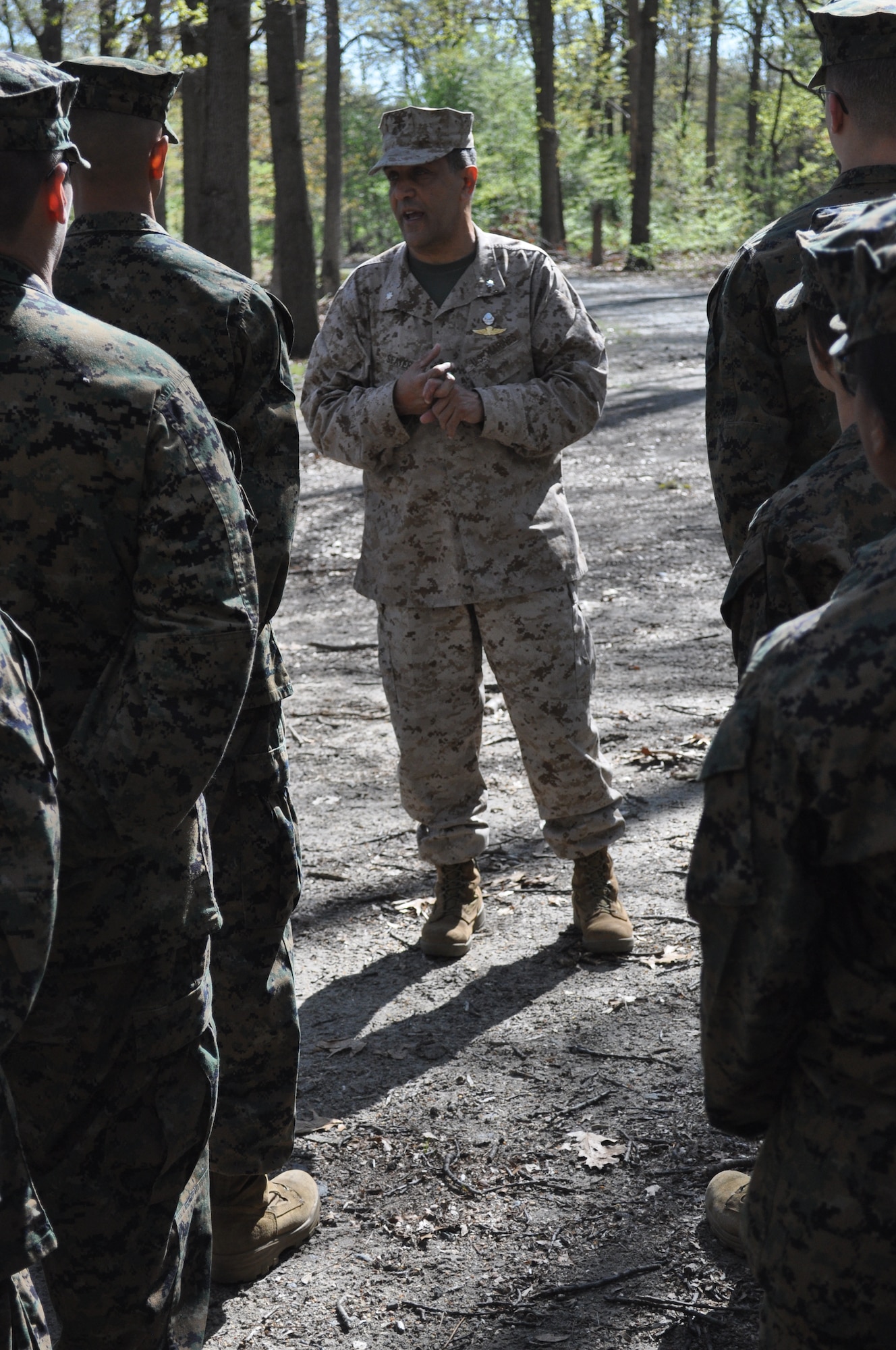 Lt. Col. James Sfayer, Abraham Clark High School Junior ROTC commanding officer, discusses the Leadership Reaction Course with cadets May 1, 2013, at Joint Base McGuire-Dix-Lakehurst, N.J.  The cadets from Roselle, N.J., spent the morning maneuvering through the course, which is designed to build unit-cohesion and preparedness. (U.S. Marine Corps photo by Cpl. David Waite/Released)