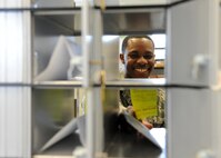 Airman 1st Class Roger Miller, 319th Communications Squadron official mail technician, places a letter in a post office box on May 13, 2013, on Grand Forks Air Force Base, N.D. The Official Mail Center delivers mail five days a week to 22 units on Grand Forks AFB. (U.S. Air Force photo/Airman 1st Class Ashley Nicole Taylor)