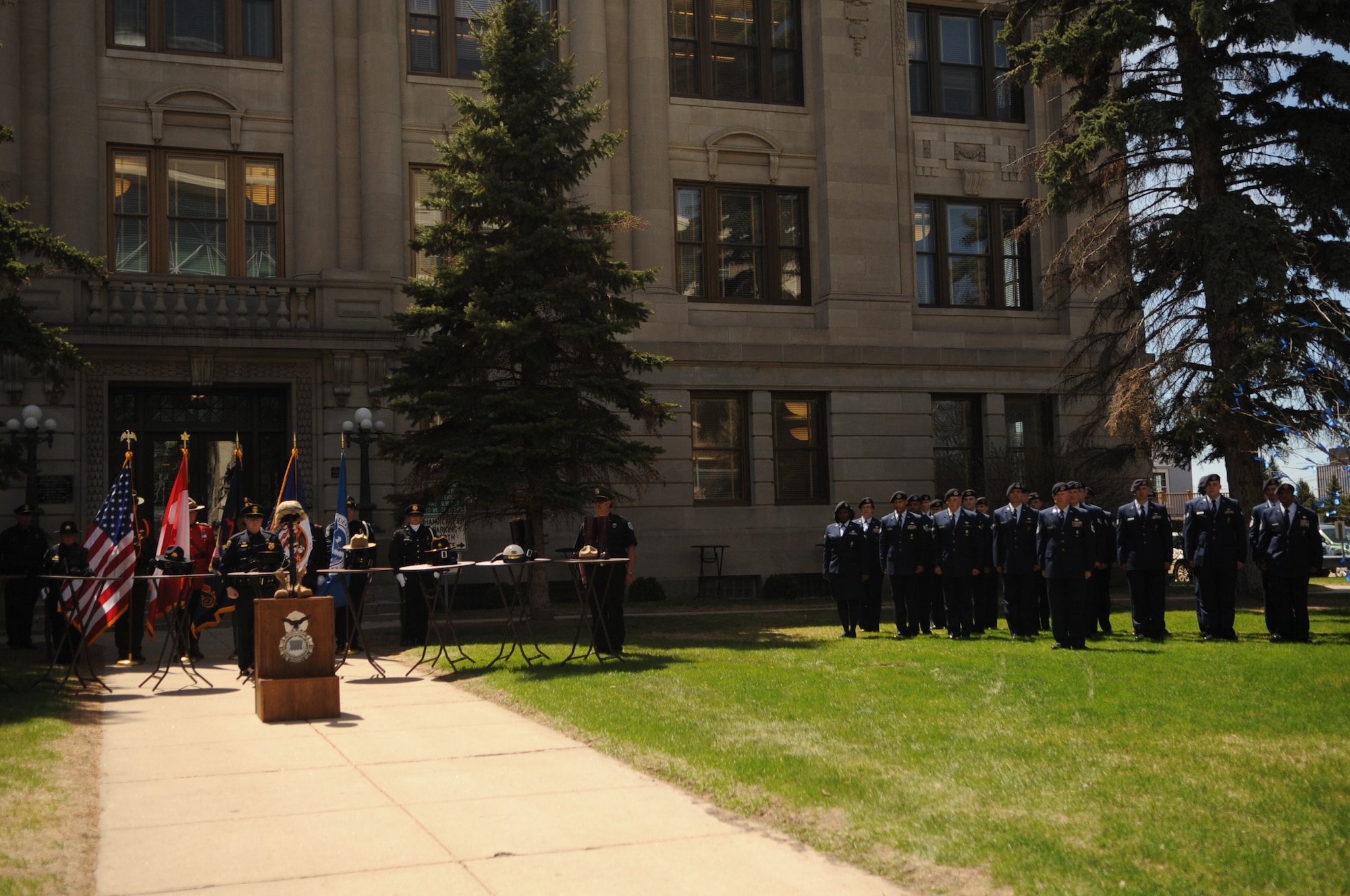 Airmen from the 319th Security Forces Squadron at Grand Forks Air Force Base, N.D., stand at attention during the 3rd Annual Northern Valley Police Week Peace Officers’ Memorial Day ceremony at Grand Forks Courthouse on May 14, 2013. The week of May 15 is designated as Police Week to honor those officers who have lost their lives in the line of duty. (U.S. Air Force photo/Staff Sgt. Amanda N. Grabiec)