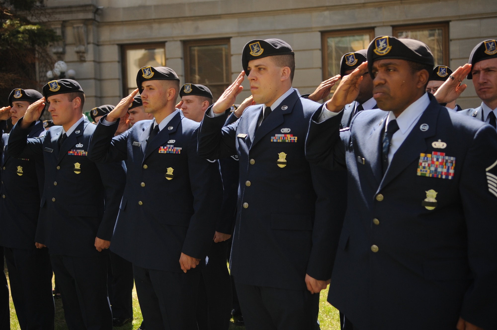 Airmen from the 319th Security Forces Squadron on Grand Forks Air Force Base, N.D., salute during the 3rd Annual Northern Valley Police Week Peace Officers Memorial Day ceremony at the courthouse in the city of Grand Forks on May 14, 2013. The week of May 15 is designated as Police Week to honor those officers who have lost their lives in the line of duty. (U.S. Air Force photo /Staff Sgt. Amanda N. Grabiec)