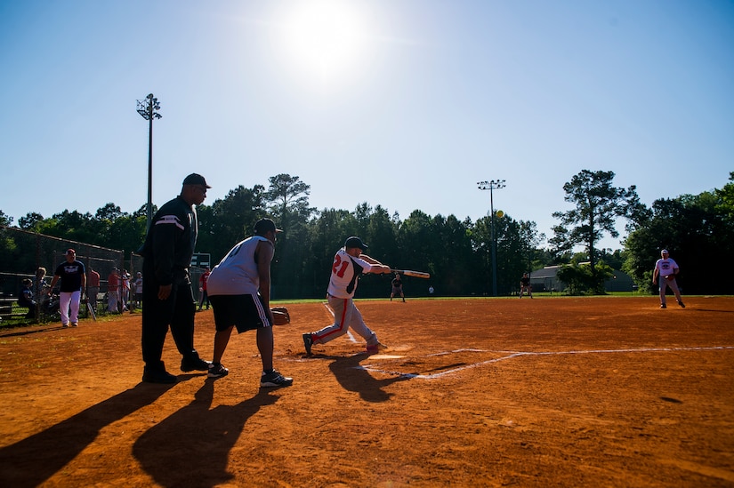 A 437th Aircraft Maintenance Squadron batter makes contact with a pitch during the 2013 Intramural Softball Season Opener May 14, 2013, at Joint Base Charleston – Air Base, S.C. The 437th AMXS team defeated the 628th Security Forces Squadron 15 – 7. (U.S. Air Force photo/Senior Airman George Goslin)