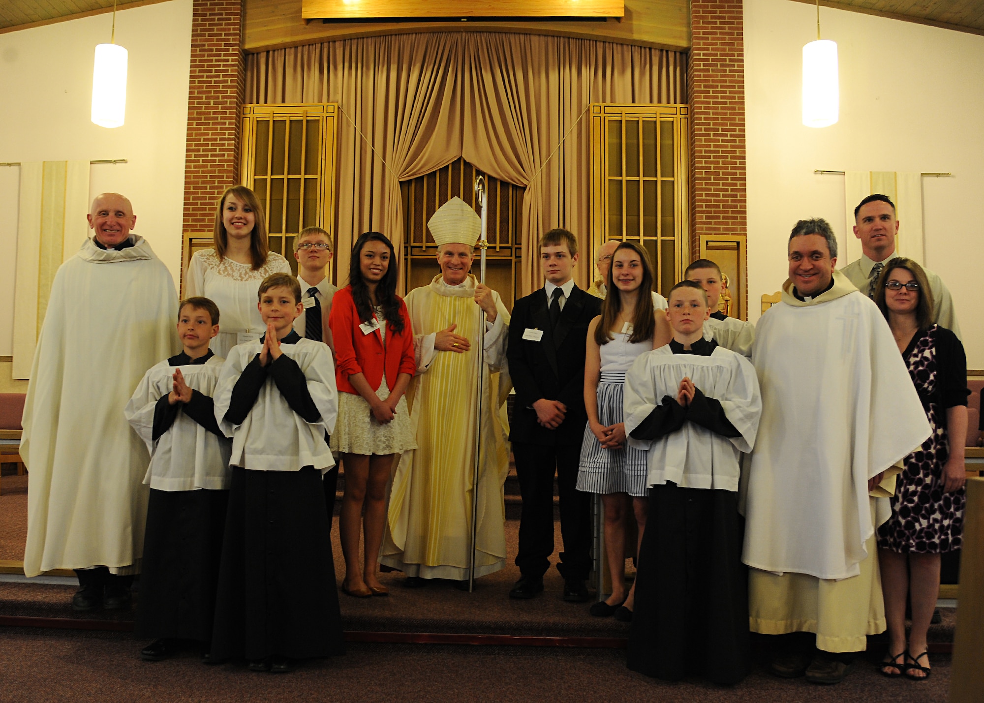 Archbishop Timothy Broglio (center), Archbishop of Military Service, and members of the Sunflower Chapel pose together after the Sacrament of Confirmation on May 11, 2013 on Grand Forks Air Force Base, N.D. Broglio visited Grand Forks AFB to bestow the Sacrament of Confirmation upon five young adults. Providing religious services such as this one to Airmen and their families directly supports the Spiritual Fitness Pillar of Comprehensive Airman Fitness, an Air Force-wide resiliency program. (U.S. Air Force photo/Airman 1st Class Xavier Navarro)