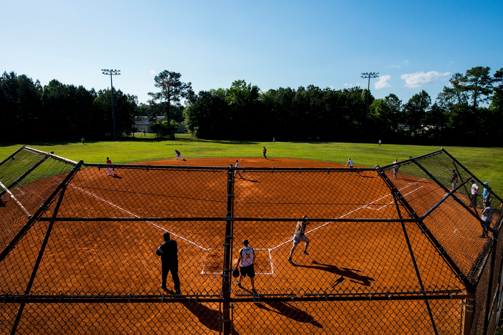 The 628th Security Forces Squadron team competes against the 437th Aircraft Maintenance Squadron team in the 2013 Intramural Softball Season Opener May 14, 2013, at Joint Base Charleston – Air Base, S.C. The 437th AMXS team defeated the 628th SFS 15 – 7. (U.S. Air Force photo/Senior Airman George Goslin)