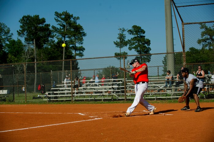 A 437th Aircraft Maintenance Squadron batter delivers a hit to the outfield during the 2013 Intramural Softball Season Opener May 14, 2013, at Joint Base Charleston – Air Base, S.C. The 437th AMXS team defeated the 628th Security Forces Squadron 15 – 7. (U.S. Air Force photo/Senior Airman George Goslin)