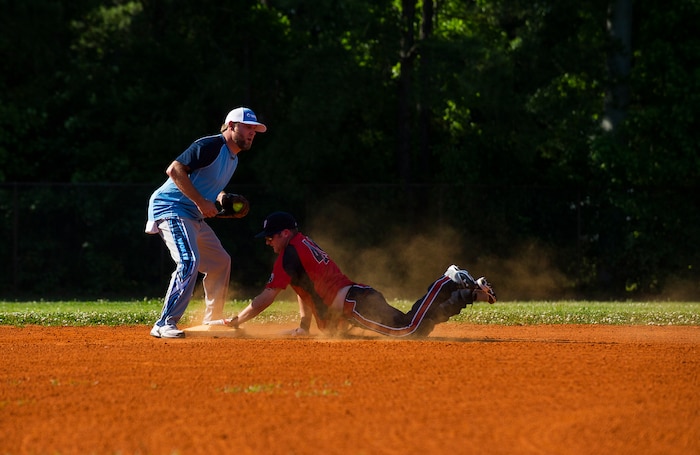 A 437th Aircraft Maintenance Squadron player slides safely into second base in the 2013 Intramural Softball Season Opener May 14, 2013, at Joint Base Charleston – Air Base, S.C. The 437th AMXS team defeated the 628th Security Forces Squadron 15 – 7. (U.S. Air Force photo/Senior Airman George Goslin)