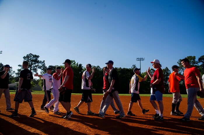 Players from the 437th Aircraft Maintenance Squadron and 628th Security Forces Squadron congratulate their opponents after the 2013 Intramural Softball Season Opener May 14, 2013, at Joint Base Charleston – Air Base, S.C. The 437th AMXS team defeated the 628th SFS 15 – 7. (U.S. Air Force photo/Senior Airman George Goslin)