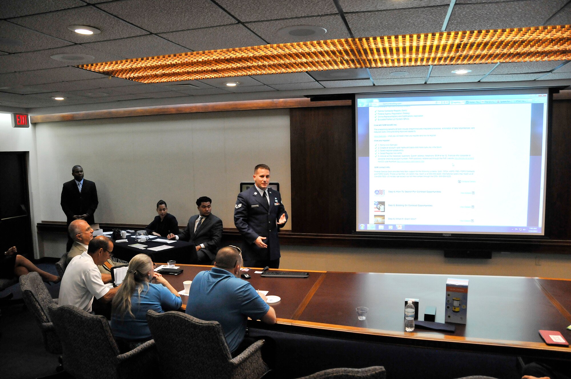 Senior Airman Jordan Zipper, 482nd Fighter Wing contracting specialist, provides an in-depth briefing to explain the complicated process of federal government contracts to more than 40 business owners at the main branch of the Community Bank of Florida in Homestead, Fla., May 14. (U.S. Air Force photo/Tim Norton)