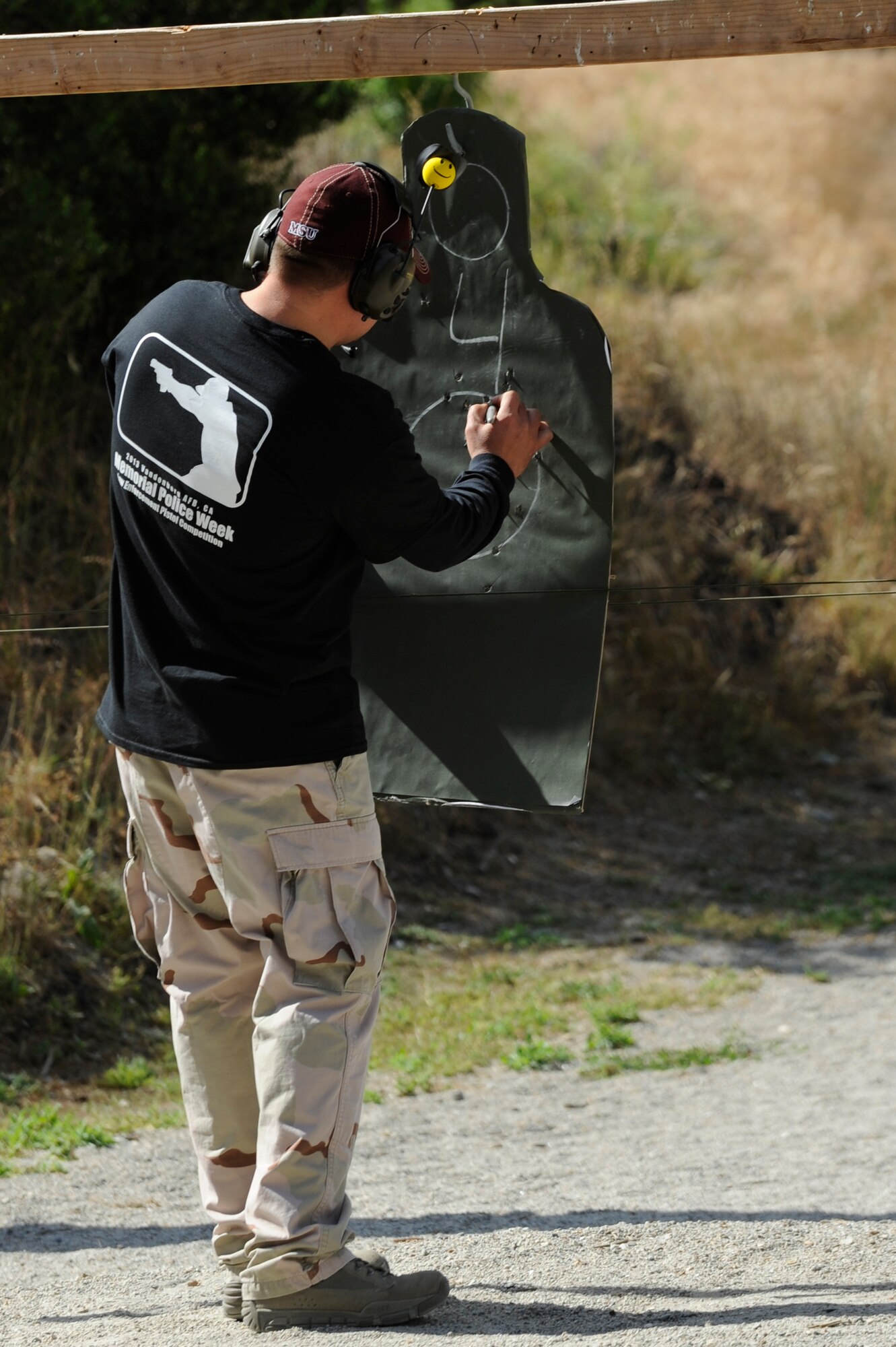 VANDENBERG AIR FORCE BASE, Calif. – A member of the 30th Security Forces Squadron marks bullet holes on a target during a Law Enforcement Pistol Shoot competition at the Combat Arms Training and Maintenance shooting range here Tuesday, May 14, 2013. The LEPS is a friendly competition between the law enforcement agencies of Santa Barbara County hosted by the 30th SFS to commemorate National Police Week. (U.S. Air Force photo/Senior Airman Lael Huss)