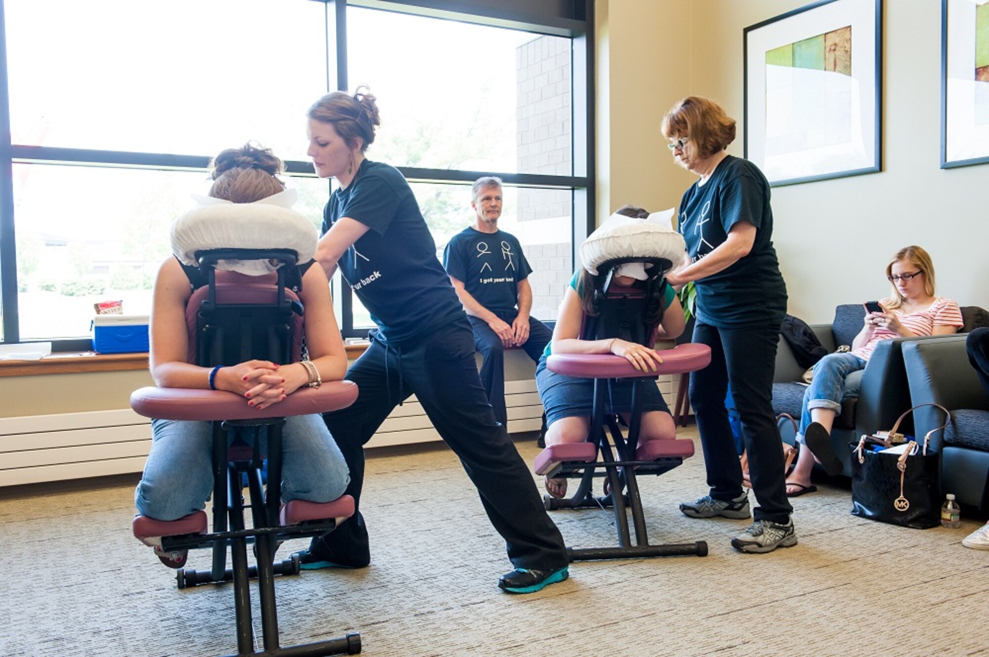 Jill Vagle and Mary Ann Pace, Ocean County Massage Institute therapists, give complimentary massages to military spouses at the Military Spouse Appreciation Day Open House May 10, 2013, on Joint Base McGuire-Dix-Lakehurst, N.J. The event hosted by the Military and Family Support Center is a salute to military spouses for their accomplishments, patriotism and sacrifices. (U.S. Air Force photo by Russ Meseroll/Released)