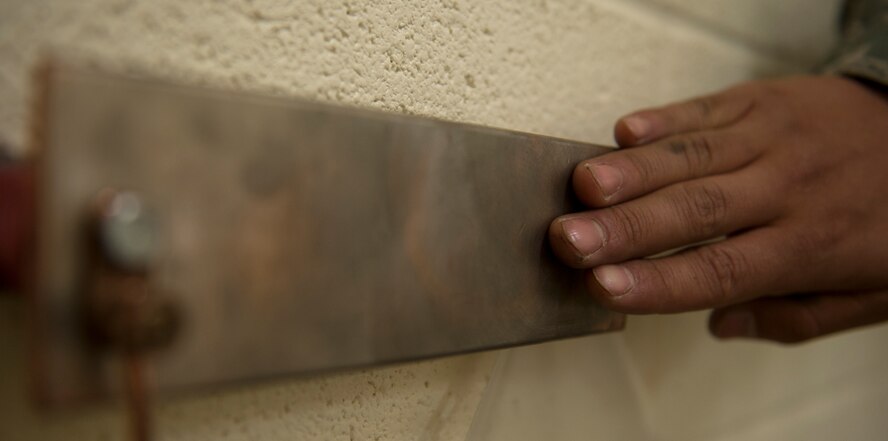 An Airman assigned to the 7th Aircraft Maintenance Squadron's electrical and environmental shop, touches a slap bar to discharge excess static electricity May 14, 2013, at Dyess Air Force Base, Texas. A slap bar is used to ground any excess static electricity from the body before working with squibs, an electrically-fired explosives, to decrease the chance of an accidental discharge of the explosive. (U.S. Air Force photo by Senior Airman Jonathan Stefanko/Released)