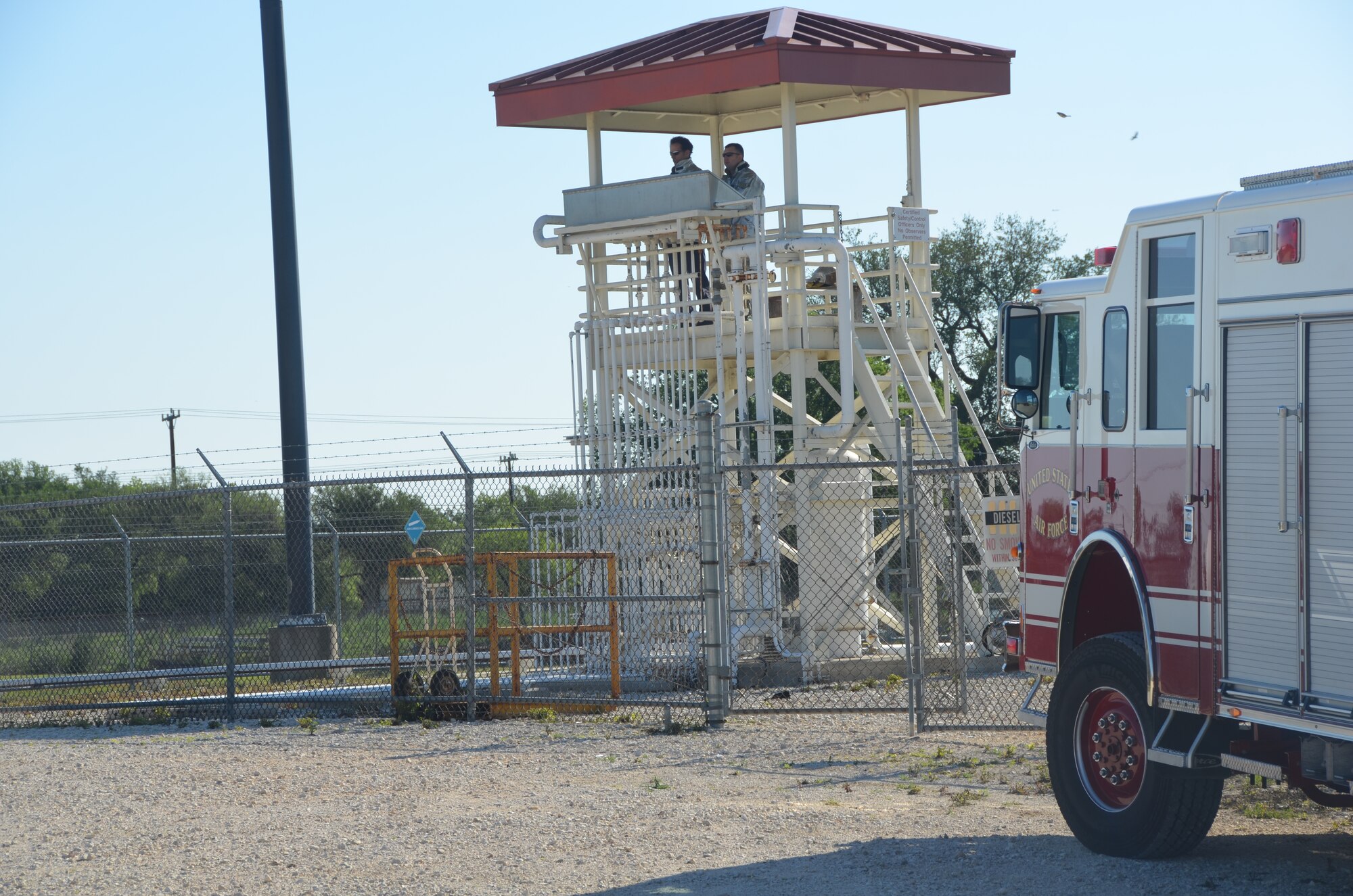 The fire on the aircraft simulator is controlled from a control tower. Operators can control how much fuel is dispensed during a live-fire exercise.  (U.S. Air Force photo by Senior Master Sgt. Minnie Jones)