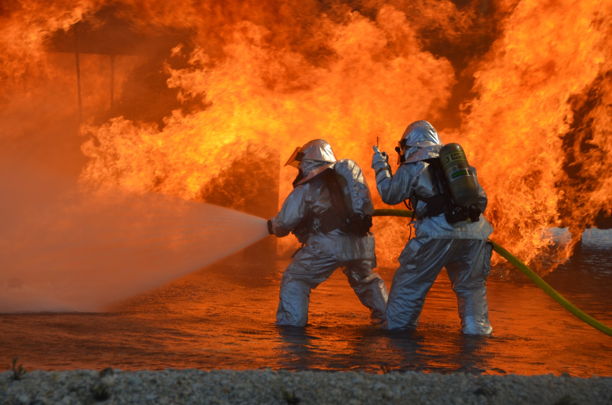 Firefighters with the 433rd Civil Engineer Squadron fire and emergency services’ flight prepare to extinguish a live fuel fire at JBSA-Randolph, Texas. May 3, 2013. These exercises are conducted in the spring and fall in order for firefighters to remain proficient in firefighting skills. (U.S. Air Force photo by Senior Master Sgt. Minnie Jones)
 
