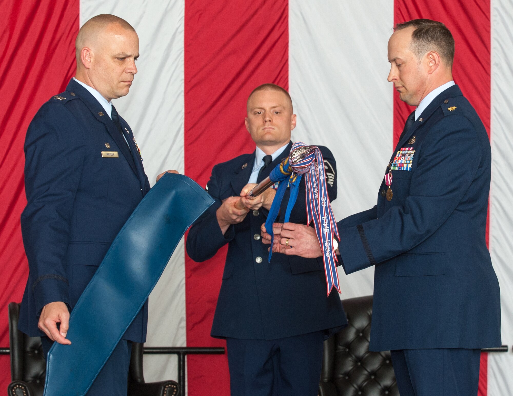 Col. John Mateer, 305th Maintenance Group commander, and Maj. Stephen Grove, 305th Maintenance Operations Squadron commander, encase the 305th MOS guidon as Master Sgt. Gregory Neuberger, 305th MOS first sergeant, lowers the guidon during the 305th MOS Inactivation Ceremony May 9, 2013, at Joint Base McGuire-Dix-Lakehurst, N.J. (U.S. Air Force photo by Wayne Russell/Released)