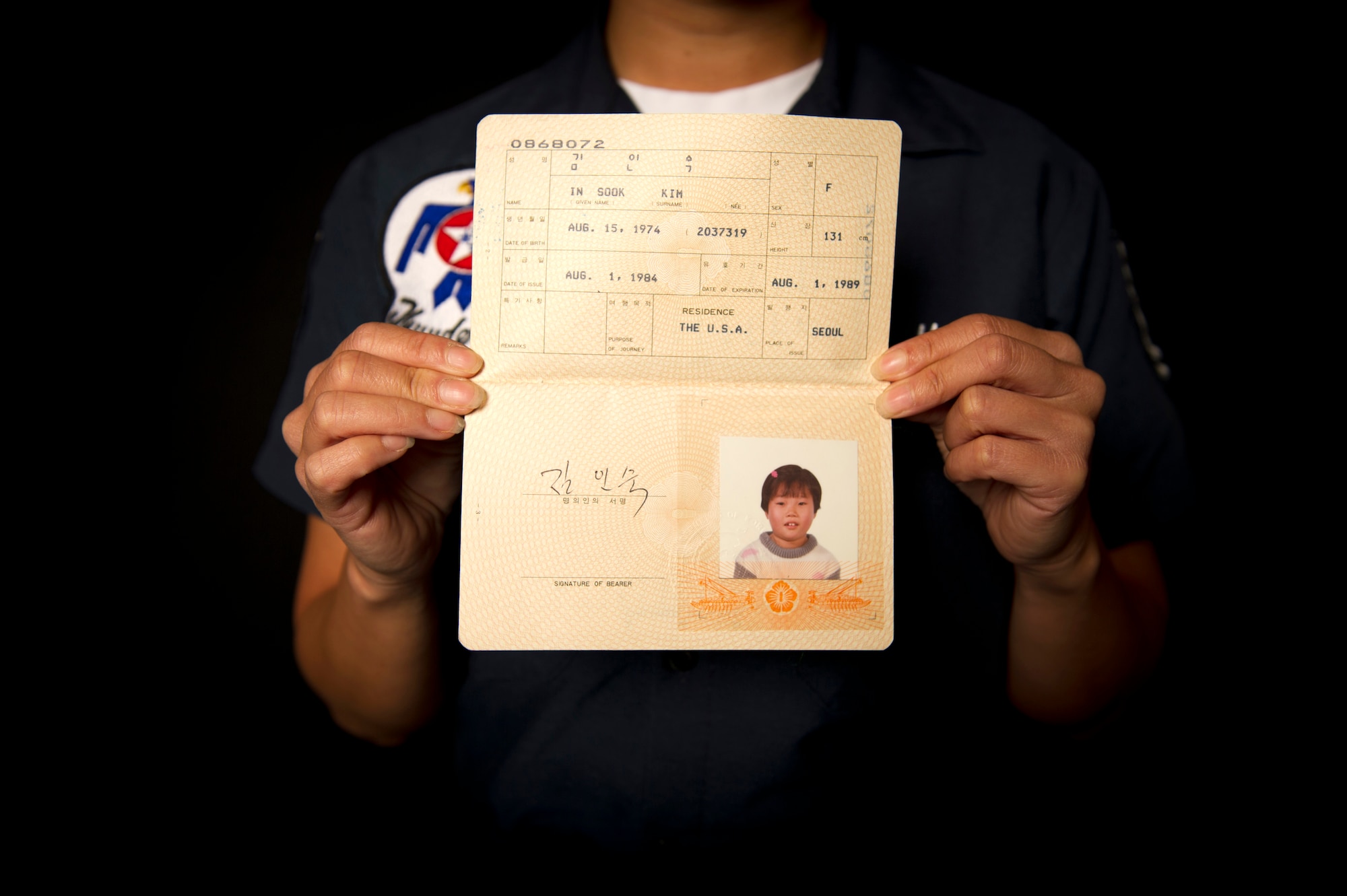 U.S. Air Force Tech. Sgt. Holly Mays holds her childhood passport, the earliest
identification document she has in her possession. It was issued in 1974,
not long after she was abandoned on the streets of South Korea at the age of
1. (U.S. Air Force photo by Tech. Sgt. Manuel J. Martinez/Released)
