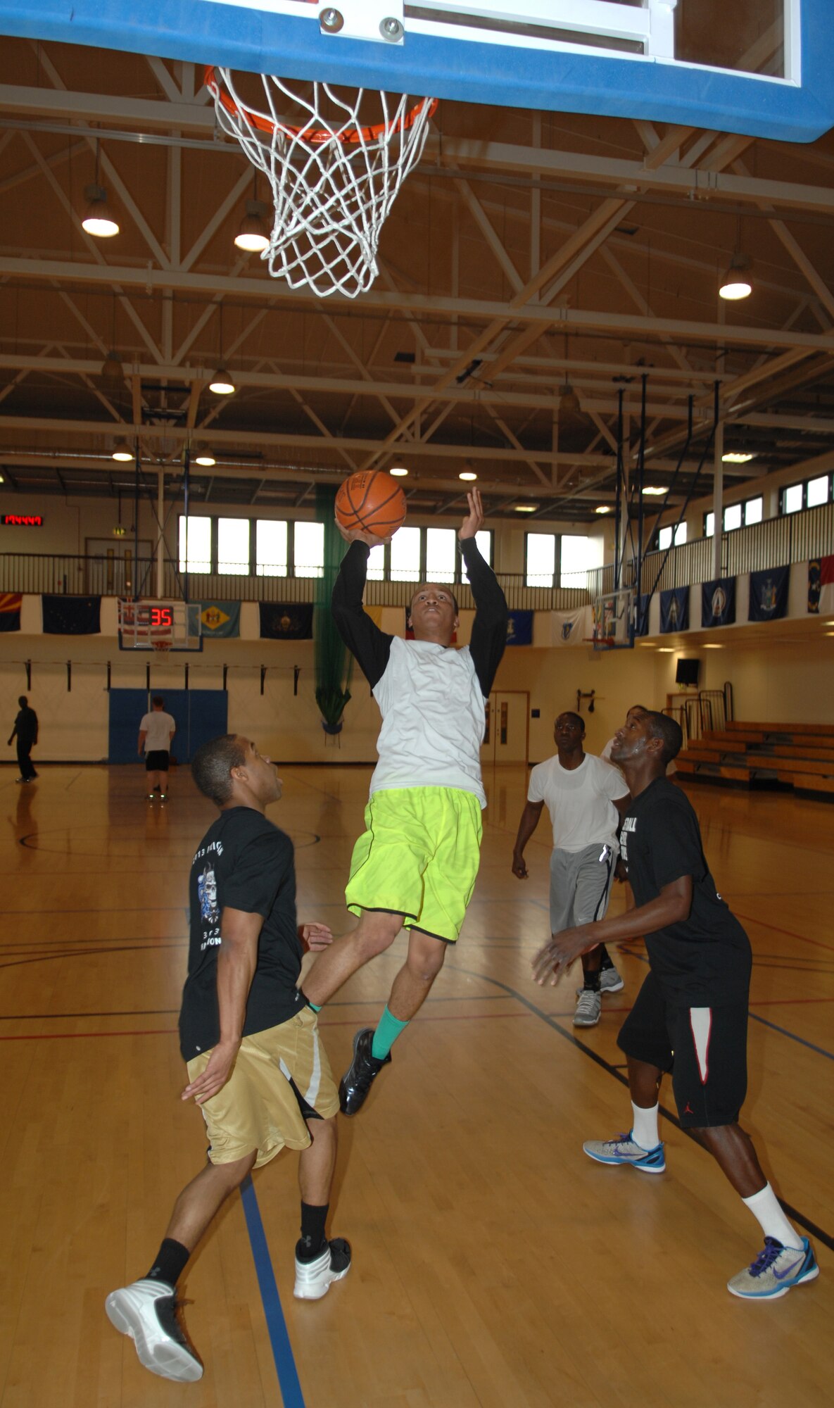 Airman 1st Class Corey Skinner, 100th Security Forces Squadron patrolman, jumps for a layup during a three-on-three basketball championship game between RAF Mildenhall and RAF Lakenheath for National Police Week May 15, 2013, at the Hardstand Fitness Center on RAF Mildenhall, England. The game pitted the winners of the previous day’s tournament against each other to decide the overall champions. (U.S. Air Force photo by Airman 1st Class Dillon Johnston/Released)