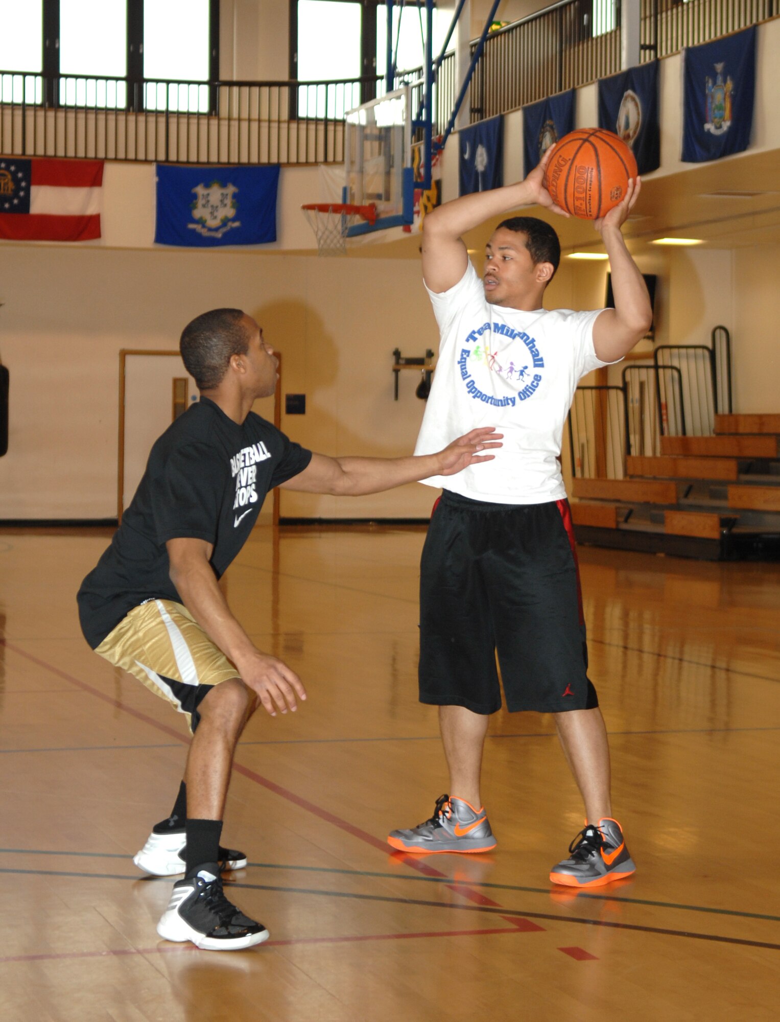 Airman 1st Class Larry Martinez, 100th Security Forces Squadron patrolman, looks for an opportunity to pass the ball during a three-on-three basketball championship game between RAF Mildenhall and RAF Lakenheath for National Police Week May 15, 2013, at the Hardstand Fitness Center on RAF Mildenhall, England. The game continued until one team scored 15 points. (U.S. Air Force photo by Airman 1st Class Dillon Johnston/Released)