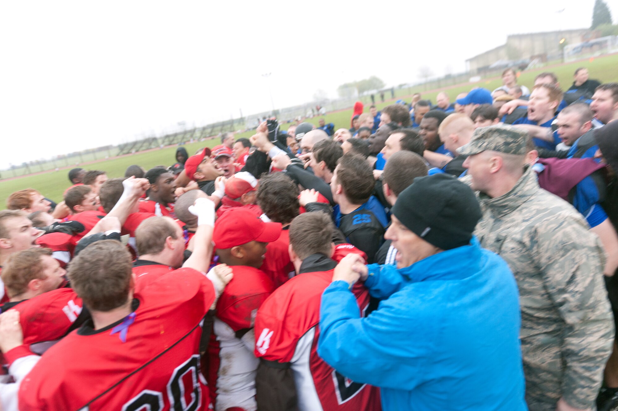 RAF ALCONBURY, United Kingdom – Members of the Peterborough Saxons, Cambridgeshire Cats and 501st Combat Support Wing give a final cheer for Bob "The Dog" Shaw at midfield after the first ever Bob "The Dog" Shaw Classic May 12 at the RAF Alconbury football field. Both teams have military personnel from RAF Alconbury, RAF Molesworth, RAF Mildenhall and RAF Lakenheath playing alongside British players. Coach Bob Shaw was a part of both teams as an offensive line coach for both the Saxons and Cats, and was the head coach for the Cats. The game was scheduled to show support for Shaw’s battle with cancer, however Shaw lost the battle the morning of the game. (U.S. Air Force photo by Staff Sgt. Brian Stives)