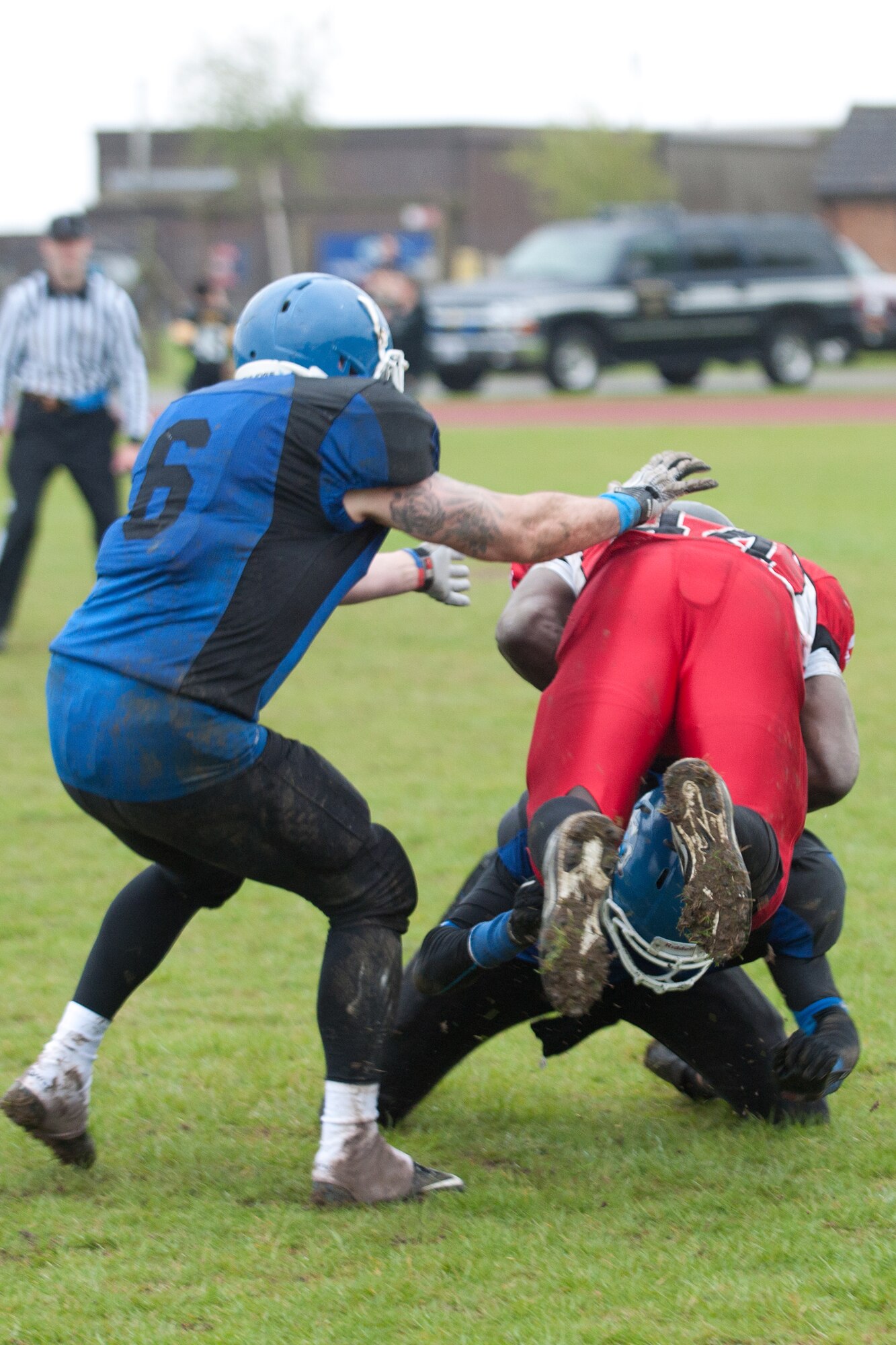 RAF ALCONBURY, United Kingdom – Samuel Anwti, Cambridgeshire Cats running back, is upended by Wayne Gumbs, Peterborough Saxons defensive back, during the fourth quarter of the first ever Bob "The Dog" Shaw Classic May 12 at the RAF Alconbury football field. These two teams have a history of playing each other for years and consider each other rivals. Both teams also have military personnel from RAF Alconbury, RAF Molesworth, RAF Mildenhall and RAF Lakenheath playing alongside British players. Coach Bob Shaw was a part of both teams as an offensive line coach for both the Saxons and Cats, and was the head coach for the Cats. (U.S. Air Force photo by Staff Sgt. Brian Stives)